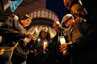 Heidi and Kenneth Cherry Sr. (from right) join friends and family in prayer during a vigil held for their son, Kenneth Cherry Jr., at the corner of Flamingo Road and Las Vegas Boulevard Friday night, February 22, in Las Vegas.